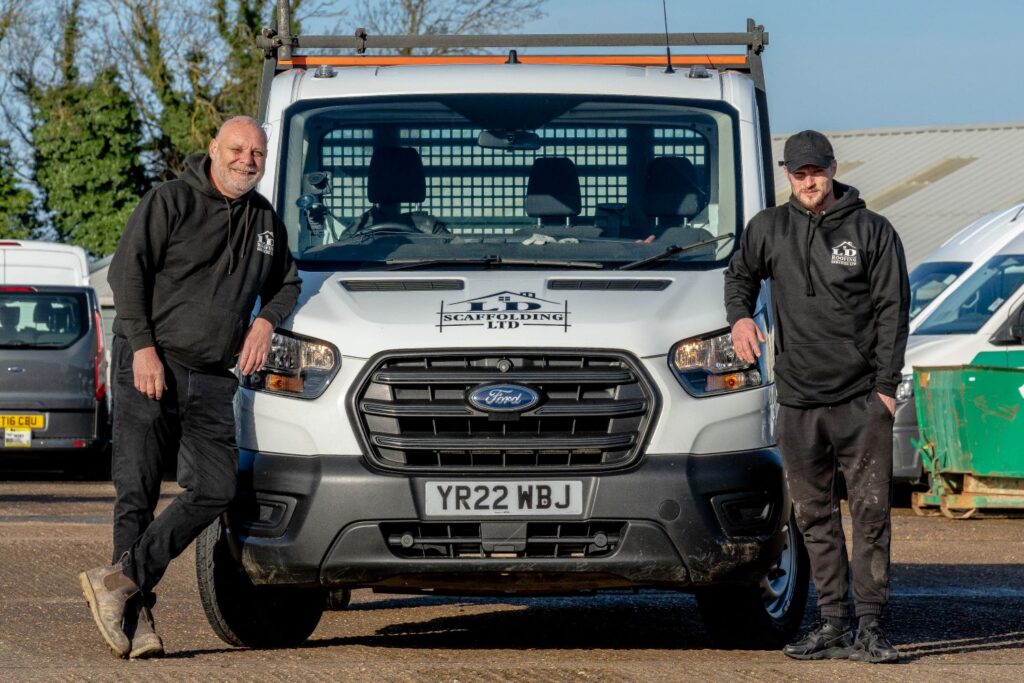 image of two ld roofing employees leaning on an ld roofing van