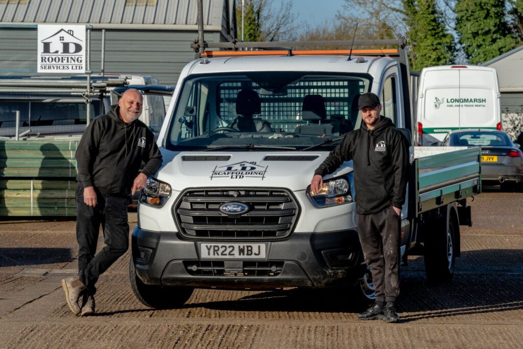 image of two ld roofing employees leaning on an ld roofing van