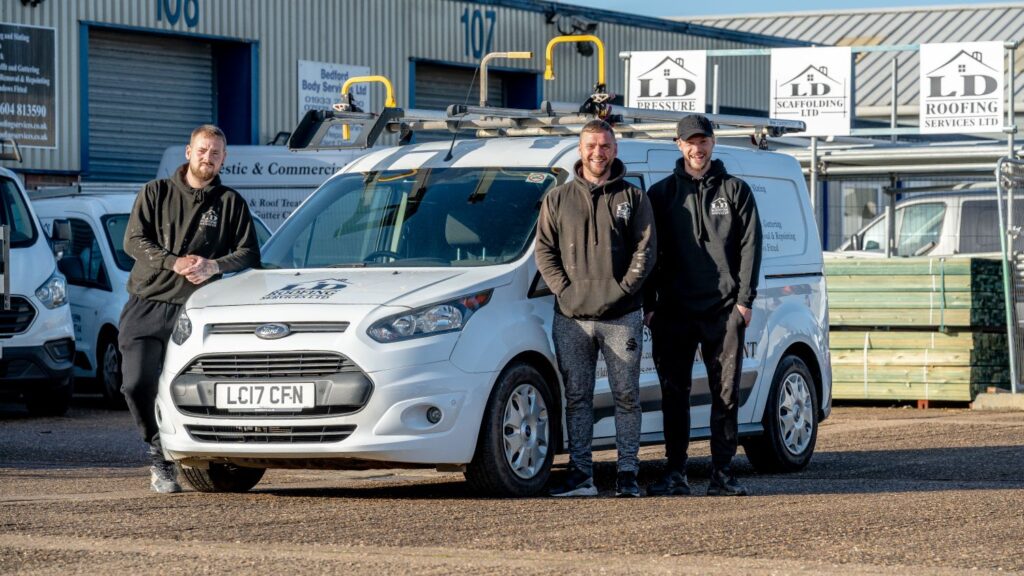 image of three ld roofing employees standing next to an ld roofing van