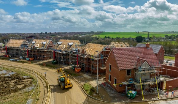 drone image of new roofs being installed in a new build development