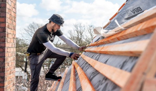 image of an ld roofing employee working on a roof