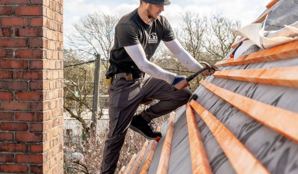 image of a ld roofing employee working on a roof